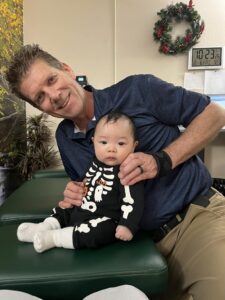 Dr Jensen with a returning infant patient