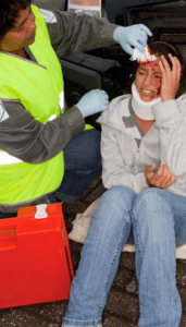 woman in a neck brace holding her head